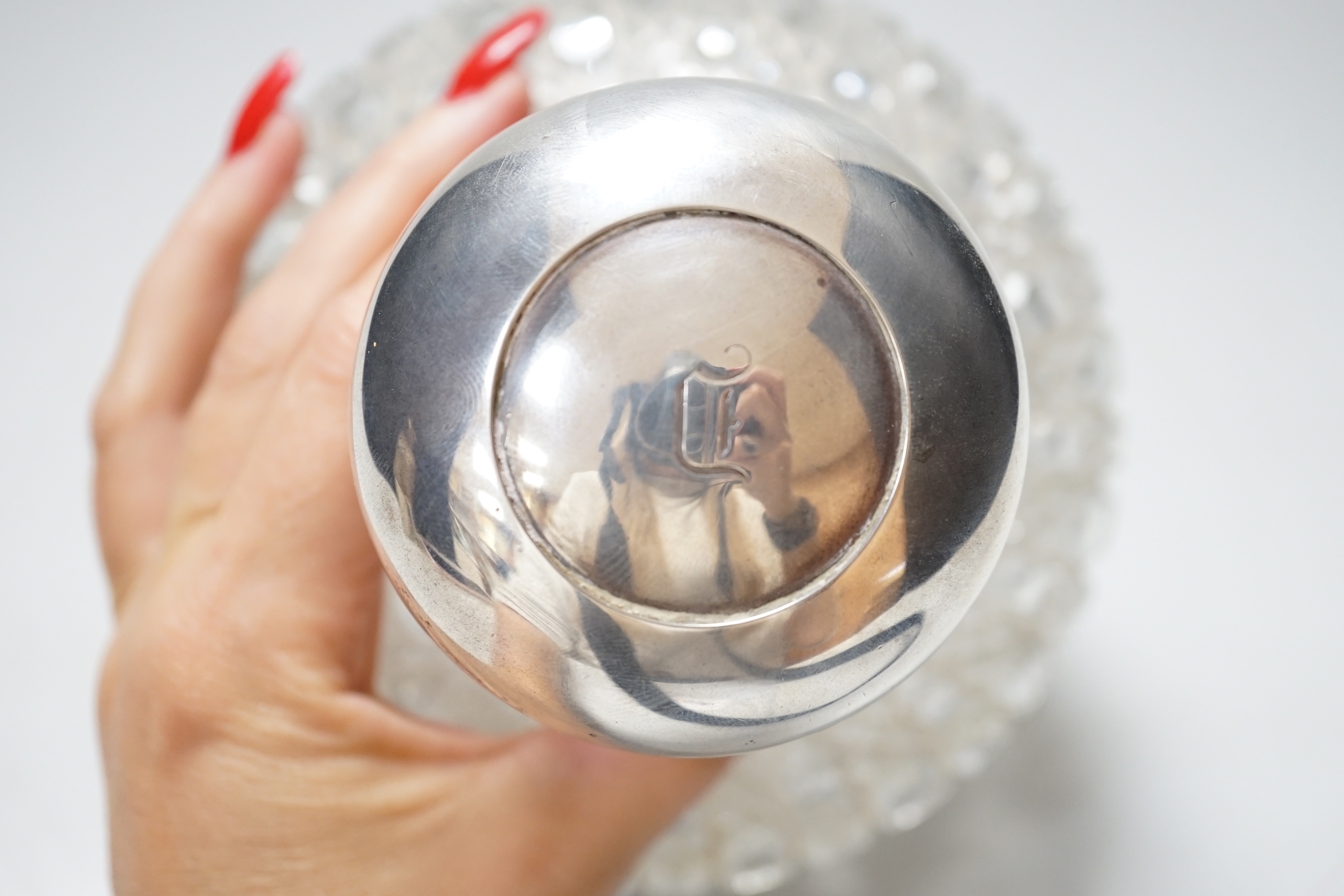 A large Victorian silver mounted globular cut glass atomiser, the lid with pump action button, the body with hobnail cutting, makers initials GB, London 1881, height 16.5cm